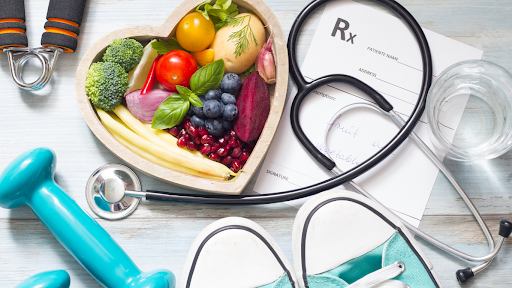 Healthy foods in a bowl and stethoscope.